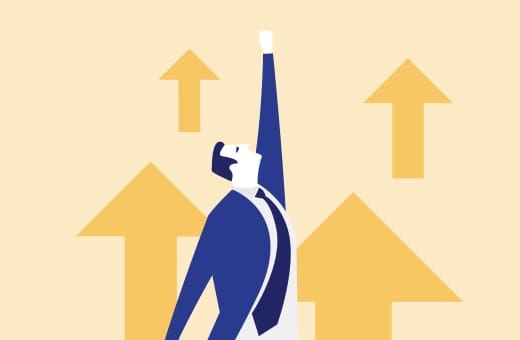 Businessperson in a blue suit reaches upward as yellow arrows point up, symbolizing growth and ambition.
