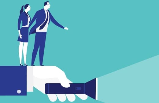 Two businesspeople stand on a giant hand holding a flashlight that shines a beam forward, symbolizing guidance.