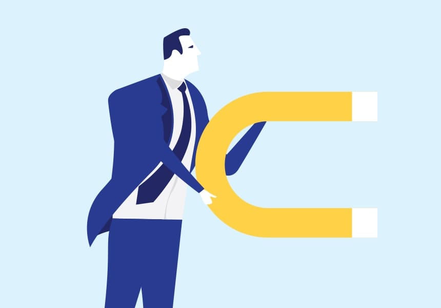 Businessman in a blue suit pulling a large yellow magnet, symbolizing attracting customers.